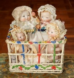 A Family of Miniature German Bisque Bye-lo Babies in Decorative Playpen 1200/1500