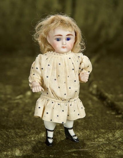 6" German all-bisque miniature doll with plump face and legs. $300/500