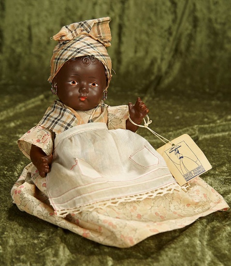 12" American brown-complexioned composition doll in original island costume. $300/400