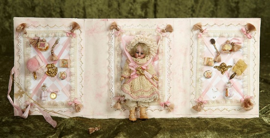 6 1/2" German bisque miniature doll on presentation card with accessories. $500/700