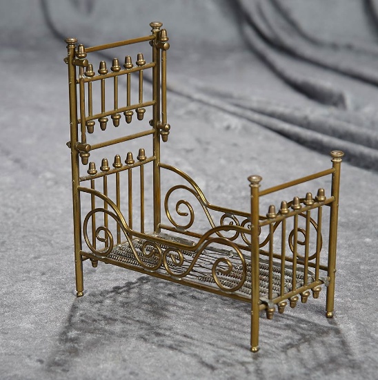 6"l. Miniature brass bed with elaborate scroll designs, probably Maerklin. $400/600