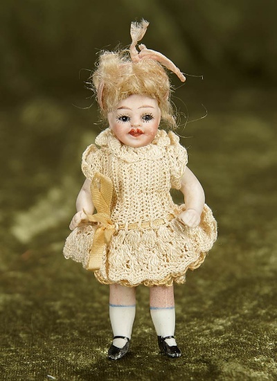 3 1/2" German all-bisque miniature doll with smiling expression. $200/300