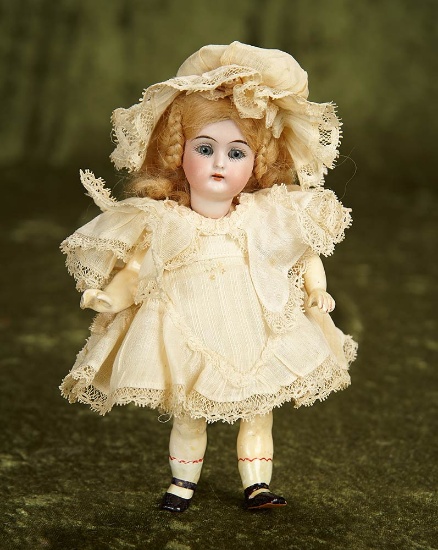 7" German bisque miniature doll with all-articulated body and wonderful costume. $400/600