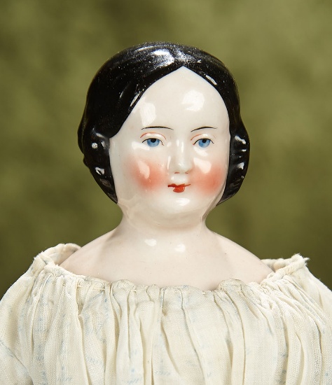13" German pink-tinted porcelain doll with slight smiling expression. $400/500