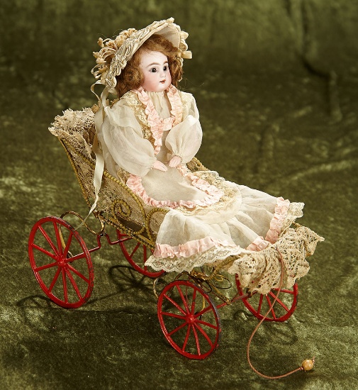 11" German bisque doll, 939, by Simon and Halbig in mechanical pull toy carriage. $800/1100