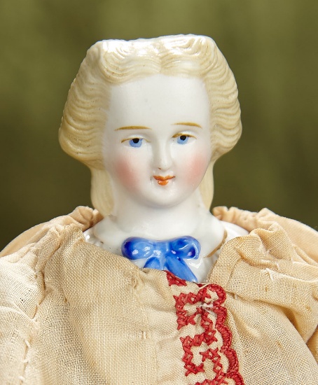 8" German bisque lady with sculpted blonde hair and blue bow at bodice. $300/400