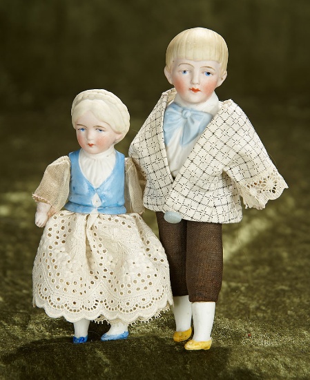 5" - 6 1/2" Two German waist-up bisque dolls by Hertwig with sculpted costumes. $200/300