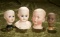 Four German bisque doll heads including Heubach Whistler and SH 749 closed mouth. $200/400
