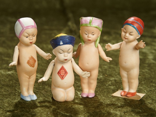 3 1/2" -4". Four German all-bisque "Queue San Baby" with sculpted hats. $200/300