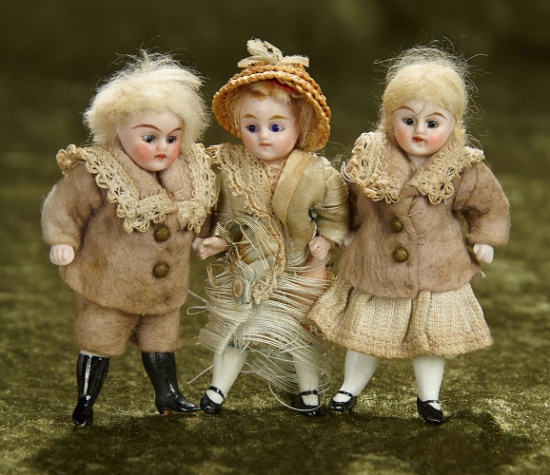 3 1/2", Three German all-bisque dolls in factory original costumes. $400/500