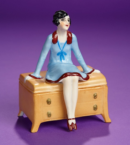 German Porcelain Powder Box "Flapper in Blue Dress Seated on Hope Chest" 300/400
