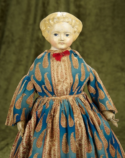 18" Early paper mache doll with blonde sculpted hair and piquant expression. $300/500