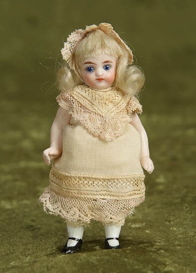 4 1/2" German all-bisque miniature doll with blue glass eyes. $400/500