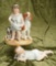 Two German all-bisque figurines of children with pets by Hertwig. $300/500