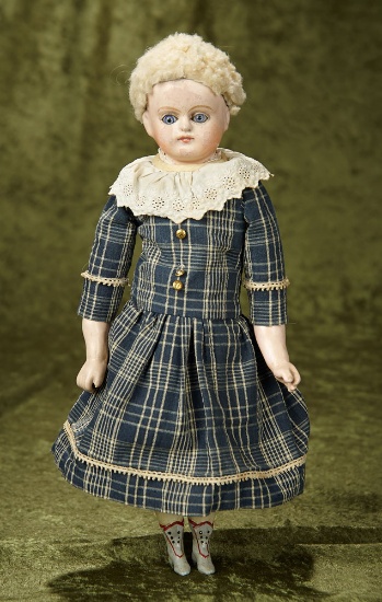 13" German paper mache child doll with glass eyes and original body. $300/400