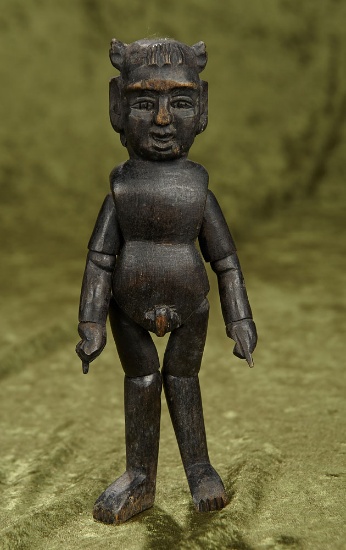 7" Interesting carved wood doll with ebony finish displaying male and female attributes.