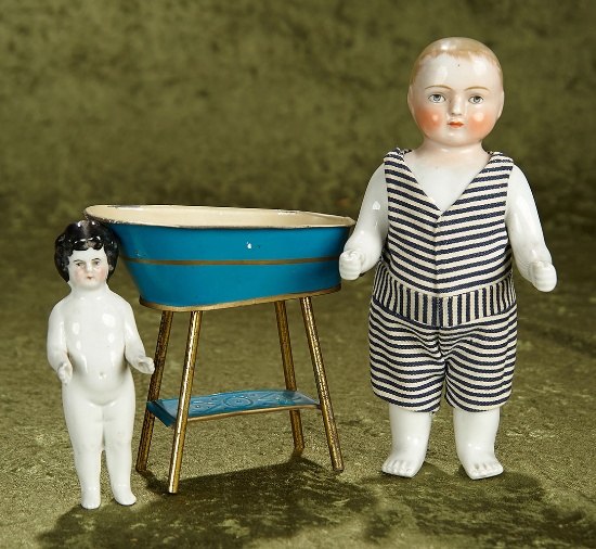 5" & 8 1/2" Two German porcelain bathing dolls and tin Maerklin toy bathtub. $400/500