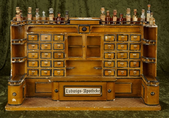 29.5" German apothecary shop "Ludwigs-Apotheke" with counter, drawers and bottles.