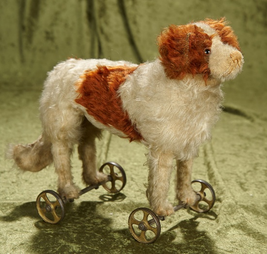 12"l. Early German mohair dog on metal wheels by Steiff, original early button. $800/1000