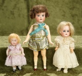 Three small German bisque dolls in various styles, nicely costumed