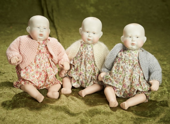 Three 8" English bisque "Tilly" babies in original smocks and sweaters, 1990. $700/900
