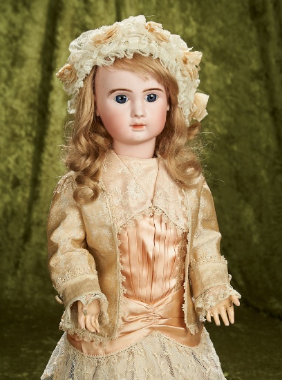22" French bisque blue-eyed bebe by Jules Steiner with original signed body. $2800/3200