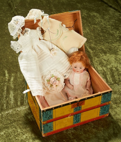 7" German all-bisque baby by Kestner in  "Baby's Trunk" with trousseau.