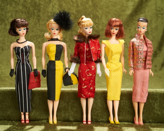 Lot of five reproduction Barbie dolls in designer fashions.