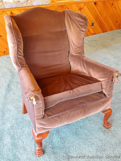 Cozy wing back chair stands 42" tall. Chair is comfortable. Frame is a little loose and creaky.