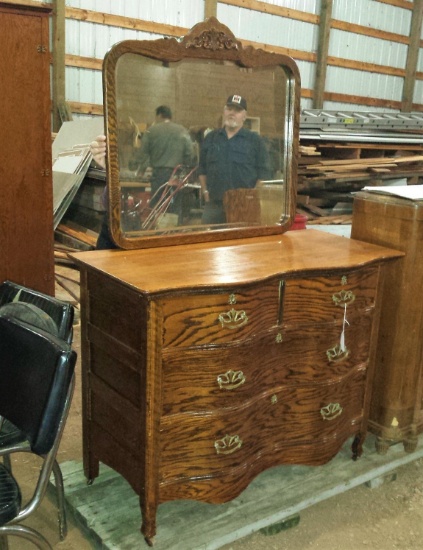 Antique serpentine four drawer dresser and wall mirror. Dresser is approx. 42-1/2" w x 19"d x 34" h.
