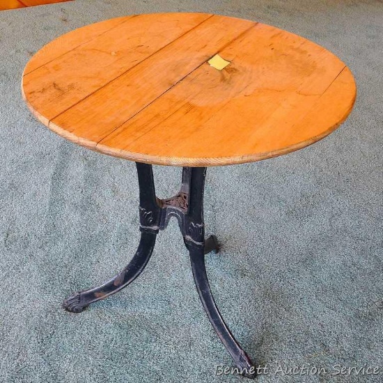 Unique round oak table with cast iron legs stands approx. 29" tall. Iron legs are very sturdy and in