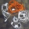 Four extension cords. Orange cord is approx. 50 ft. Heavy white cord approx. 25 ft.