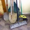 Seven yard tools incl. two brooms, garden rake, two spade shovels, leaf rake and scraper.