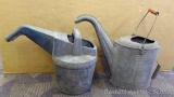 Vintage water can with wooden handle. No holes noted; watering can, no holes. Both are in good
