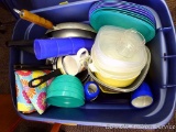 Sterlite tote with lid filled with pots, skillet, camping plates, bowls, glasses and more.