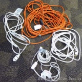 Four extension cords. Orange cord is approx. 50 ft. Heavy white cord approx. 25 ft.