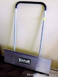 Aluminum Man Plow, appears new. Approx. 3 ft. wide x 4 ft. high.