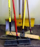 Two brooms, garden rake with fiberglass handle, garden hoe, scraper, snow shovel and flat edge