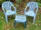 Two resin yard chairs with one side table are all sturdy and in overall good shape. With a coat of
