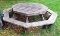 Large octagon shaped picnic table is 5' across and quite heavy. Table is sturdy and in overall good