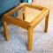 Hardwood and glass end table is in good condition and matches lot #325 and #316. Measures 26