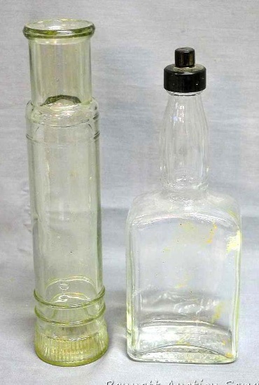 Unique spyglass shaped bottle; other bottle is marked 'Loaned by A.R. Winarick Inc. Made in USA',