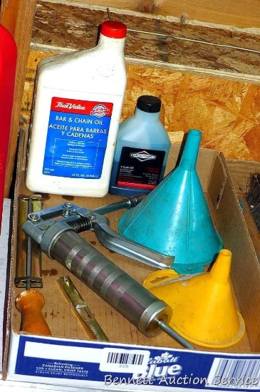 Small grease gun; saw chain file; partials of bar & chain oil, two cycle oil; funnels. No shipping.