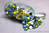 One quart blue Ball jar with zinc lid is filled with marbles. Some of the solid colored marbles