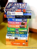 Twelve assorted puzzles including one 2000 piece puzzle - a great winter project. Seller stated that