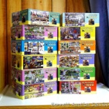 Twelve Hometown Collection 1000 piece puzzles. Seller stated that all of the pieces are in zipper