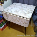 Handy little table with drop leaves and an easy to clean formica top measures 28