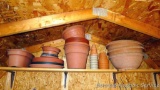 Assorted flower pots and trays including plastic and clay.