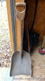 Antique steel grain shovel with a carved one piece wooden cross handle.