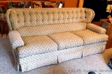 Comfortable sofa is in decent condition overall. Has folding panel reinforcer under cushions. Tear